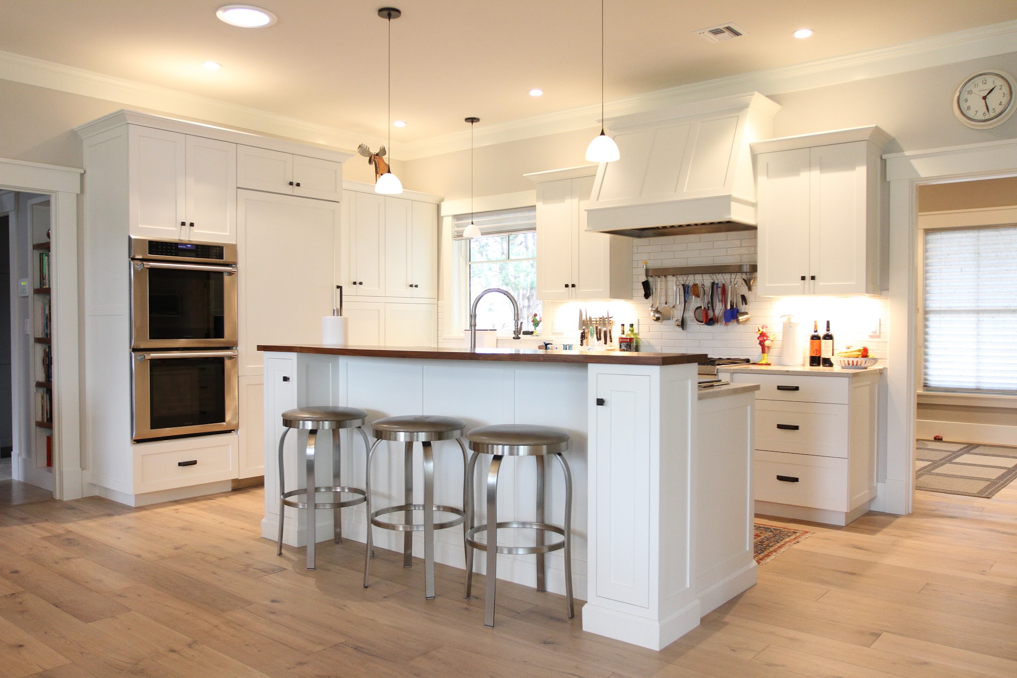 Custom white shaker kitchen cabinetry and island built by The Interior